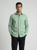 Man wearing a Sage-green Echo Shirt by BUNO paired with black pants.
