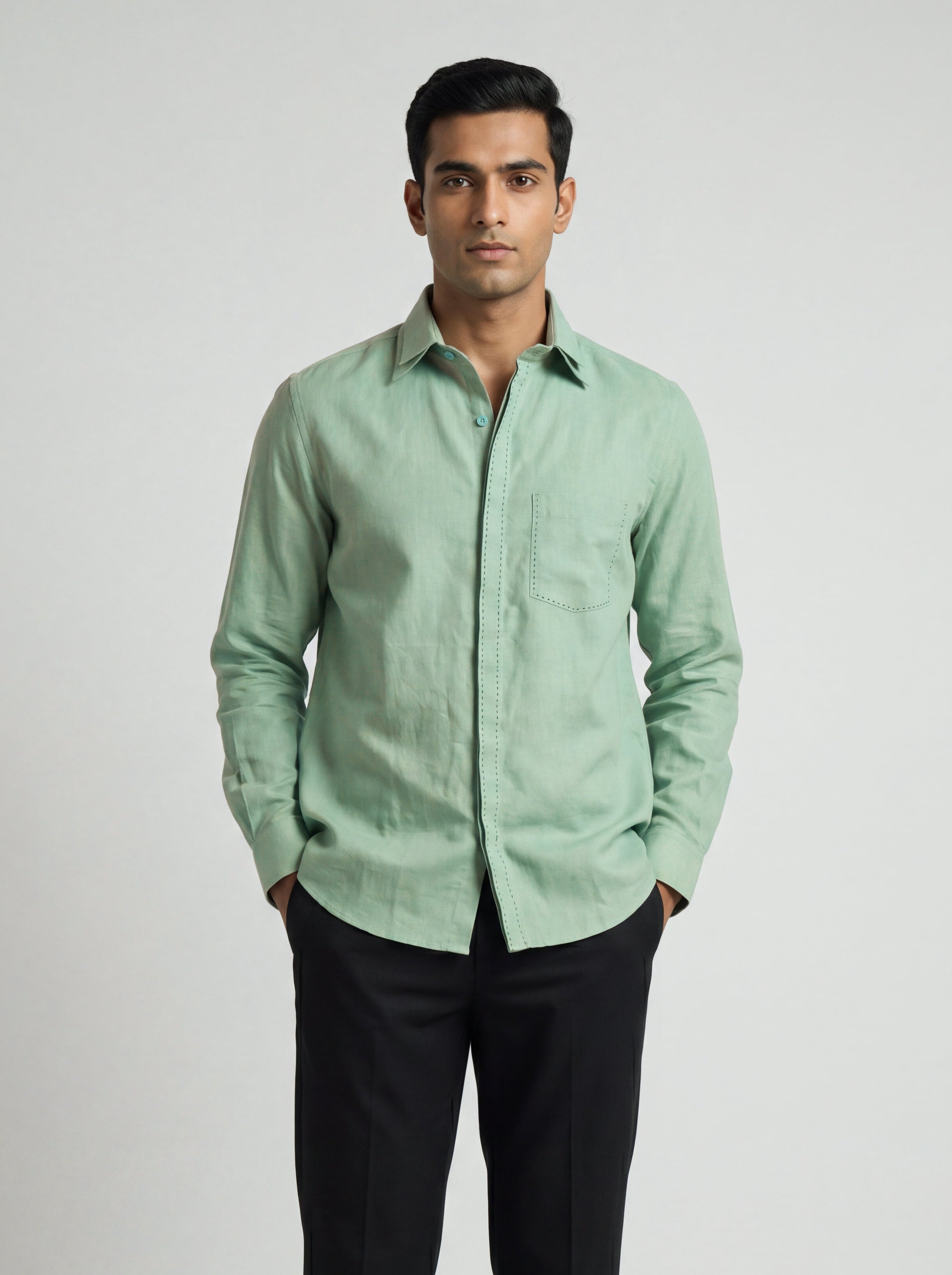 Man wearing a Sage-green Echo Shirt by BUNO paired with black pants.